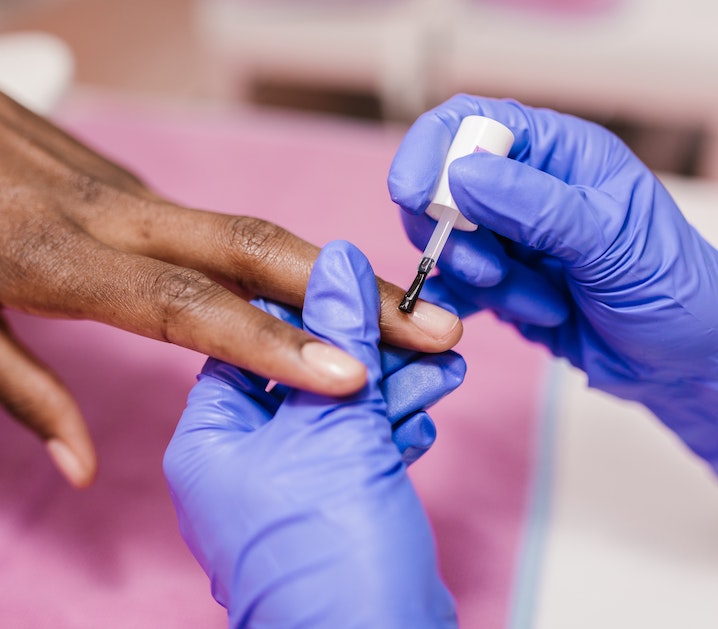 applying cuticle oil to nails